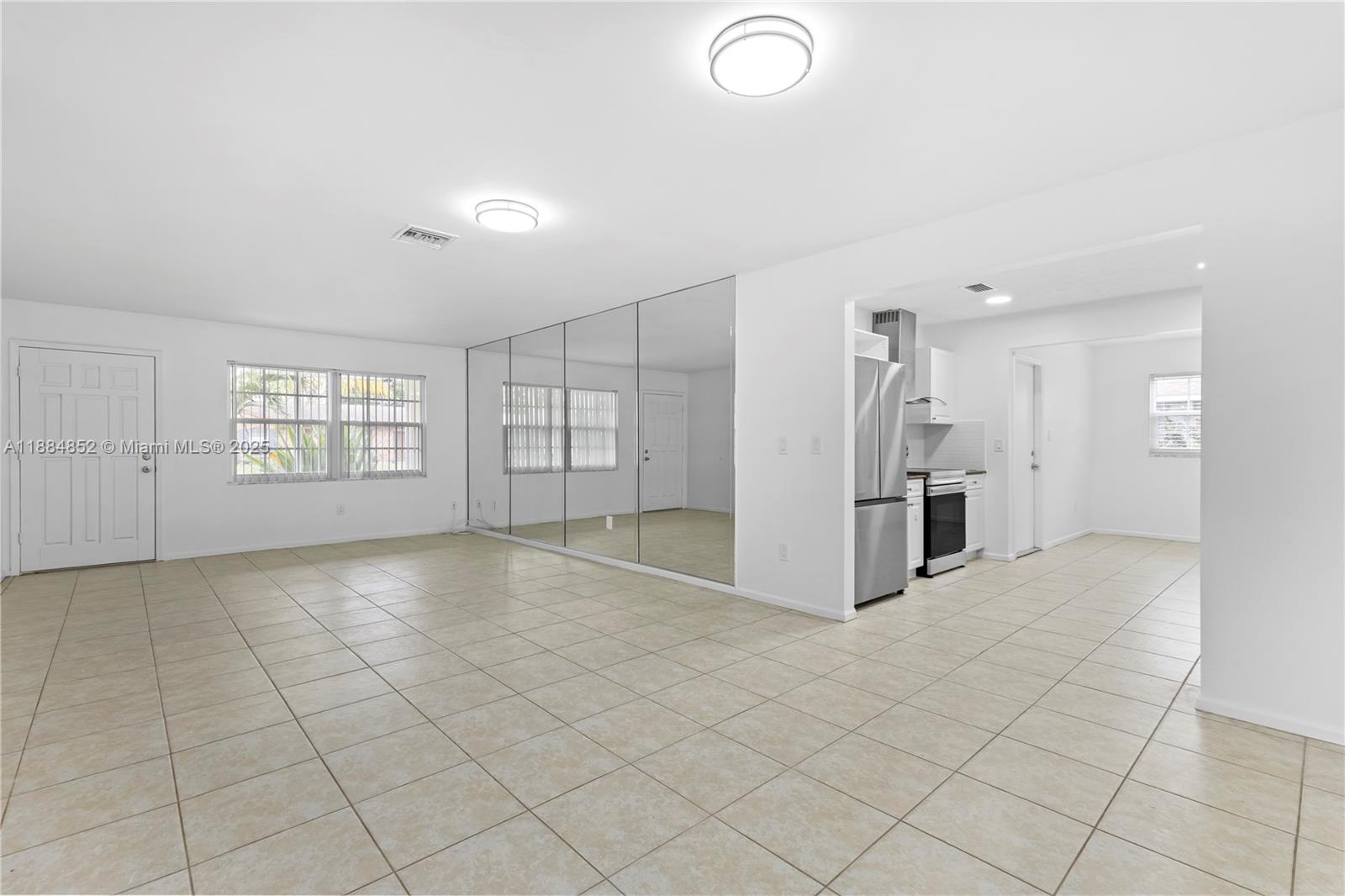 1517 Southeast Pitcher Road Port St. Lucie, FL 34952 - Photo 9 of 26 an empty room with windows