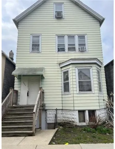a view of a house with a yard and a balcony