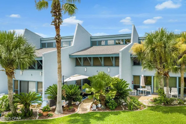 an aerial view of residential houses with outdoor space and swimming pool