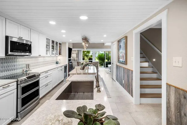 a kitchen with a sink cabinets and wooden floor