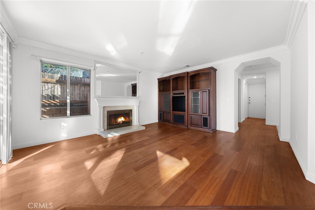 6598 Bradford Court Rancho Cucamonga, CA 91701 - Photo 14 of 48 a view of empty room with wooden floor and fireplace