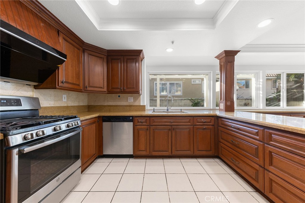 6598 Bradford Court Rancho Cucamonga, CA 91701 - Photo 21 of 48 a kitchen with a sink a stove and cabinets