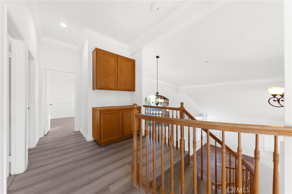 6598 Bradford Court Rancho Cucamonga, CA 91701 - Photo 28 of 48 a view of a hallway with wooden floor
