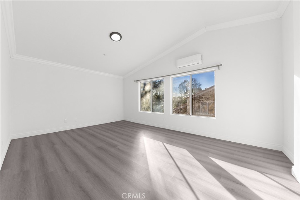 6598 Bradford Court Rancho Cucamonga, CA 91701 - Photo 30 of 48 a view of an empty room with wooden floor and a window