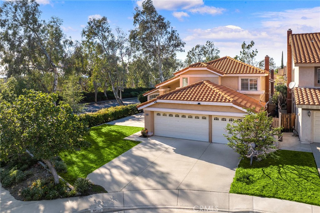 6598 Bradford Court Rancho Cucamonga, CA 91701 - Photo 3 of 48 a view of a white house with a yard and plants