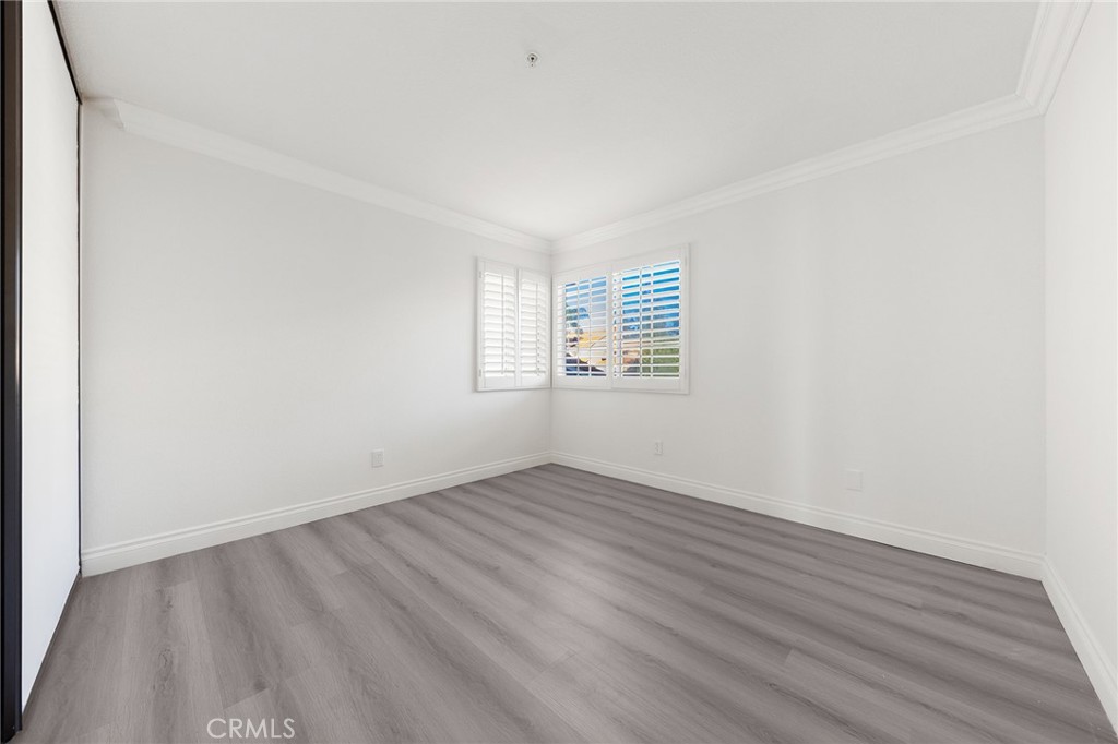 6598 Bradford Court Rancho Cucamonga, CA 91701 - Photo 36 of 48 an empty room with wooden floor and windows