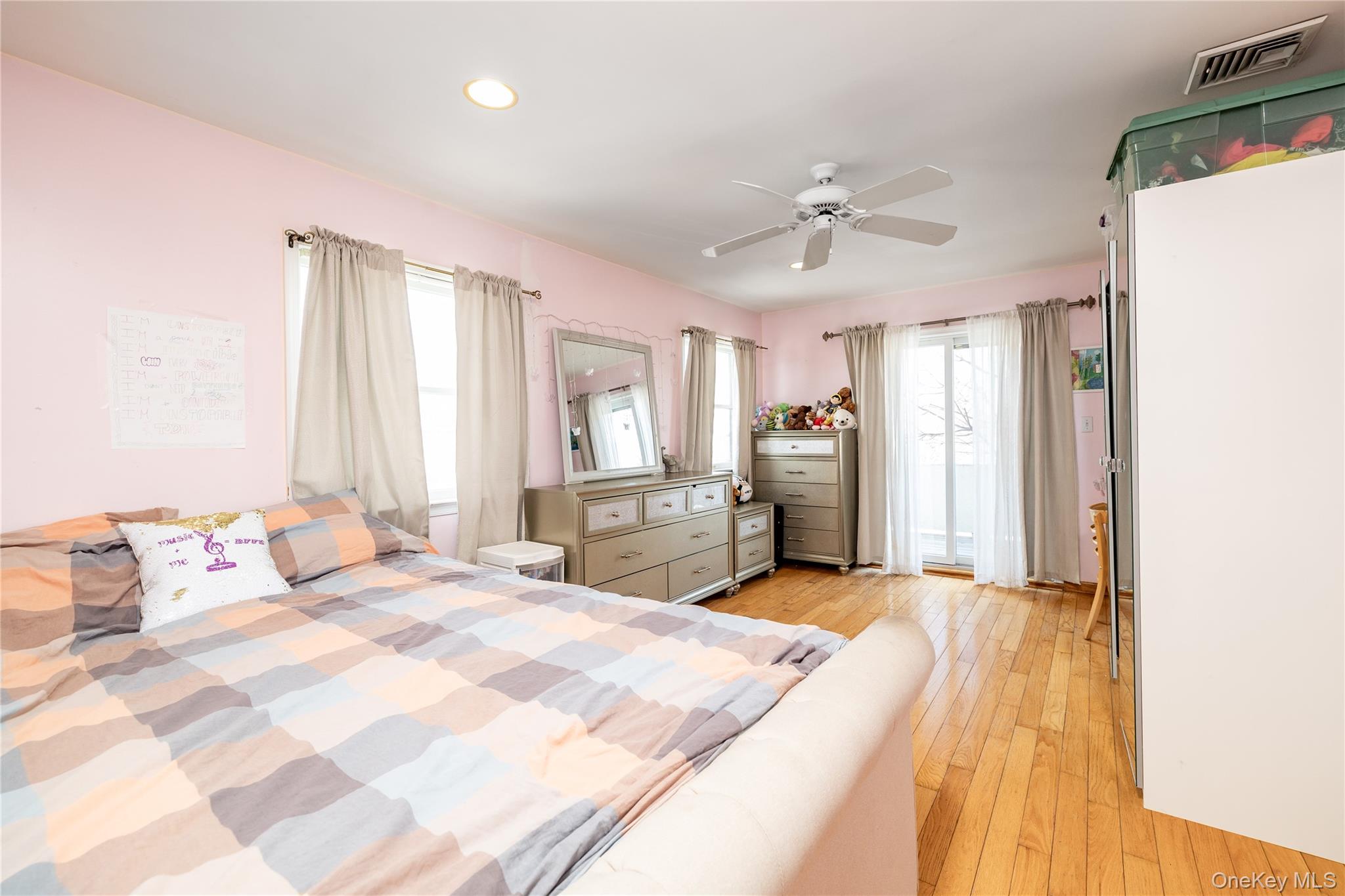 458 East Pine Street Long Beach, NY 11561 - Photo 14 of 26 a spacious bedroom with a bed and a chandelier