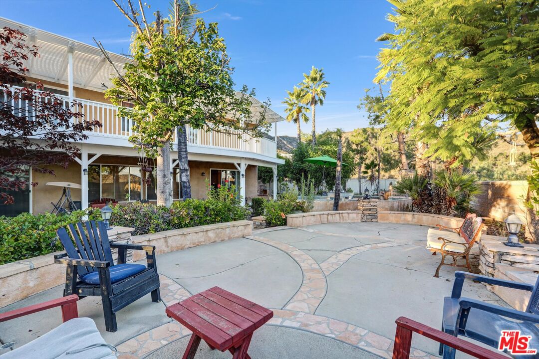 24383 Topacio Court Wildomar, CA 92595 - Photo 38 of 39 a front view of a house with a yard glass top table and chairs