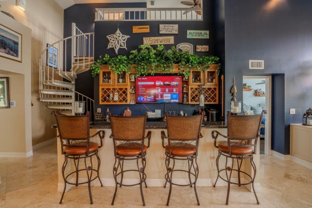 708 Mainsail Circle Jupiter, FL 33477 - Photo 25 of 68 a table and chairs in front of a building