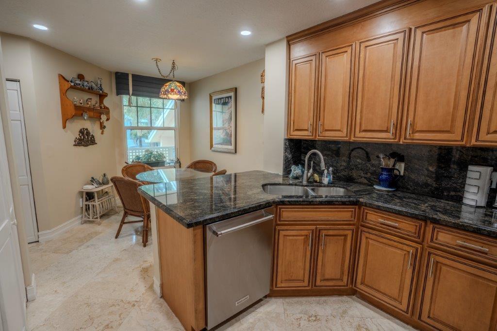 708 Mainsail Circle Jupiter, FL 33477 - Photo 29 of 68 a kitchen with stainless steel appliances granite countertop a sink stove and cabinets