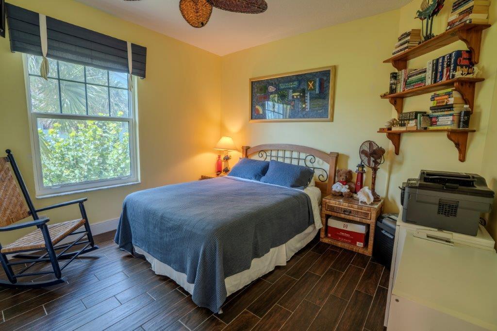 708 Mainsail Circle Jupiter, FL 33477 - Photo 38 of 68 a bedroom with a bed and wooden floor