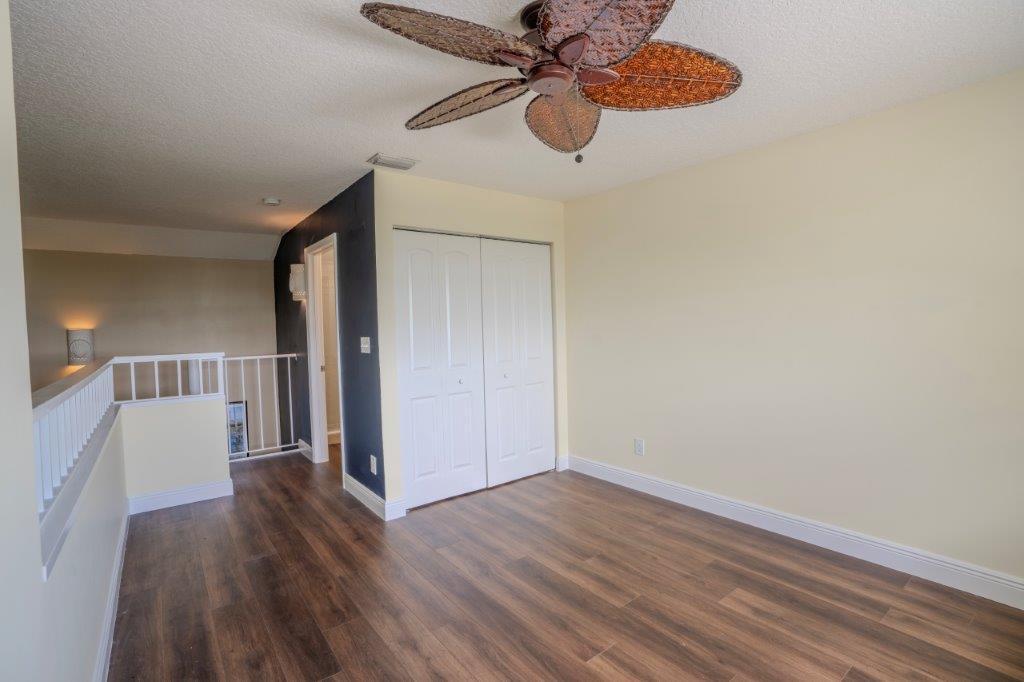 708 Mainsail Circle Jupiter, FL 33477 - Photo 43 of 68 a view of a room with wooden floor closet and a ceiling fan