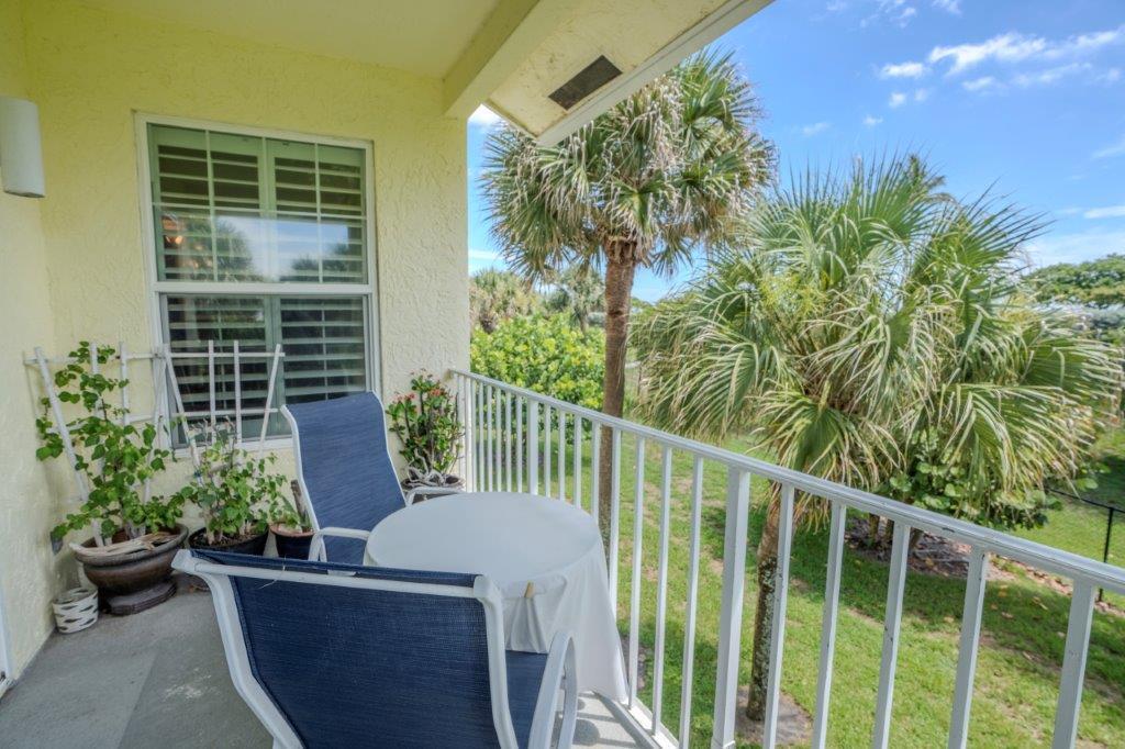 708 Mainsail Circle Jupiter, FL 33477 - Photo 48 of 68 a view of a balcony with chair and potted plants