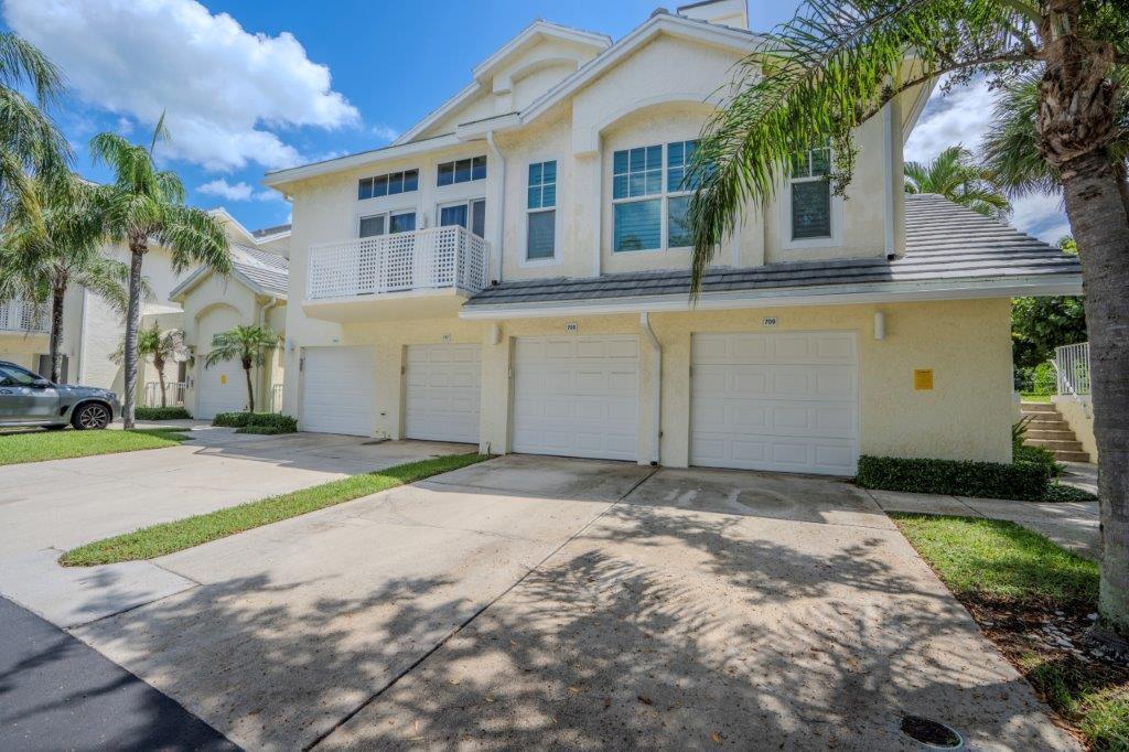 708 Mainsail Circle Jupiter, FL 33477 - Photo 51 of 68 a view of a house with a yard and palm trees