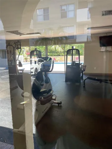 a room with gym equipment and a large window