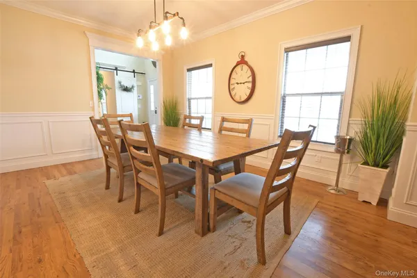 a view of a dining room with furniture and a kitchen