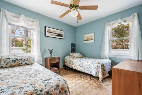 a bedroom with two beds and a window