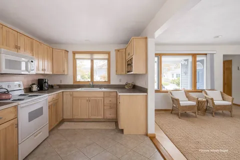 a kitchen with white cabinets and white appliances