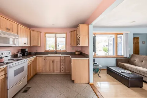 a kitchen with a stove a sink and a refrigerator