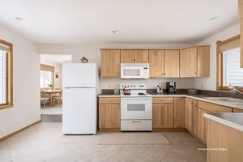 a kitchen with a refrigerator sink stove and cabinets