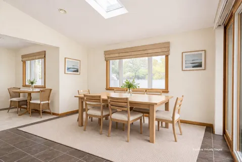 a dining room with furniture and window