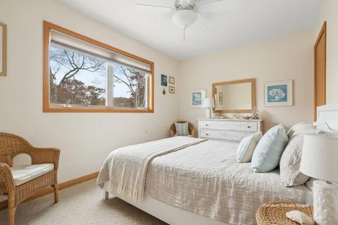 a bedroom with a bed and a painting on the wall