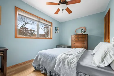 a bedroom with a bed and a painting on the wall