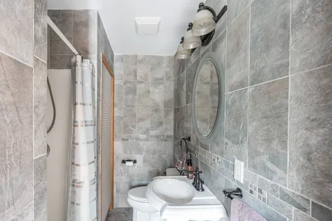 a bathroom with a sink toilet and shower