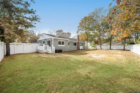 a view of a house with a yard and sitting area