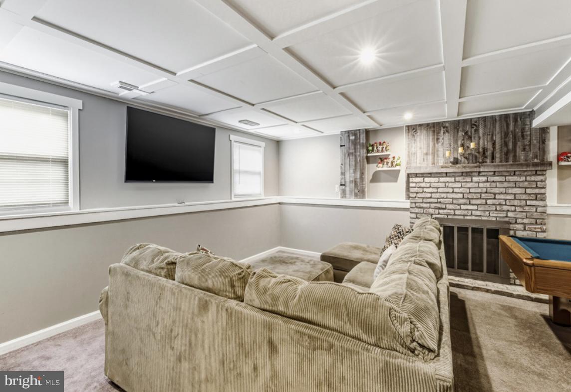 27 Lincoln Drive Clementon, NJ 08021 - Photo 25 of 31 a living room with furniture a flat screen tv and a fireplace