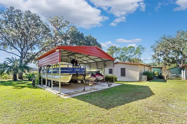 a view of a house with a yard patio and fire pit