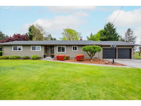 a front view of house with yard and outdoor seating
