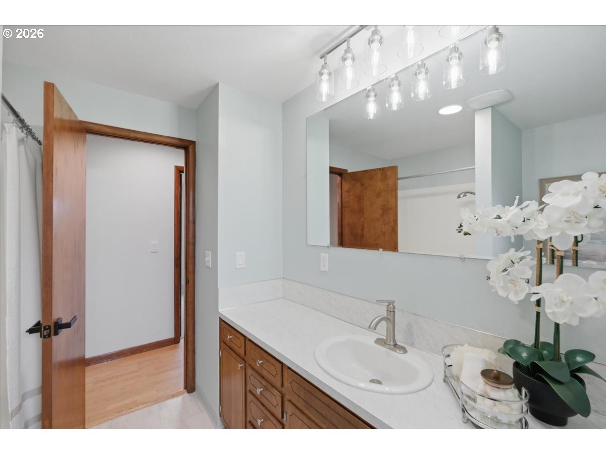 2610 Shaff Road Southeast Aumsville, OR 97325 - Photo 13 of 25 a bathroom with a sink a light fixture and a mirror