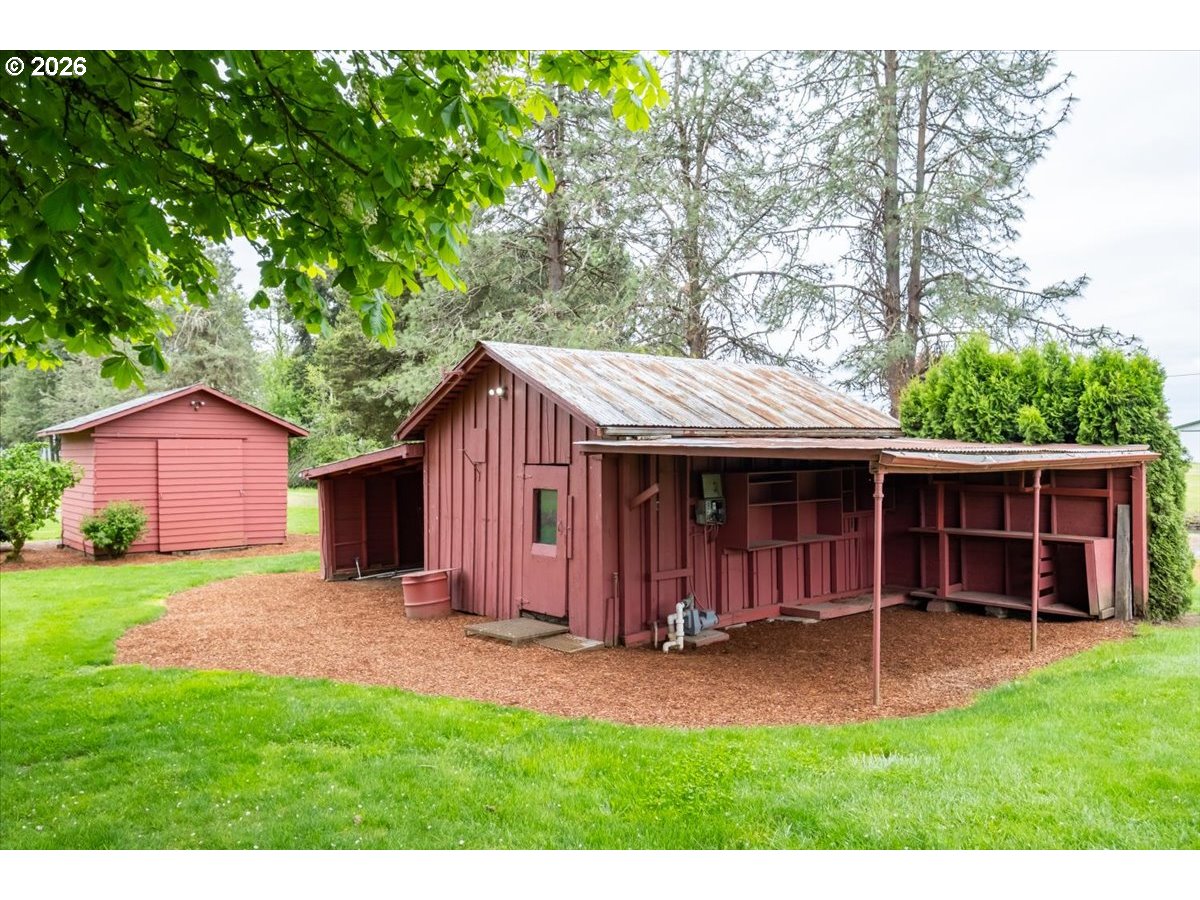 2610 Shaff Road Southeast Aumsville, OR 97325 - Photo 4 of 25 a view of a barn with a big yard and large trees