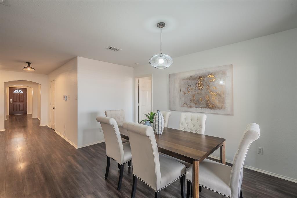 10541 Rising Knoll Lane Fort Worth, TX 76131 - Photo 11 of 27 a view of a dining room with furniture wooden floor and chandelier