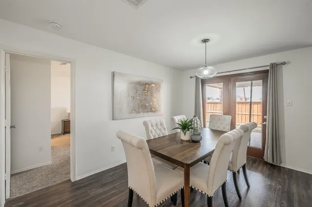 a view of a dining room with furniture wooden floor and chandelier