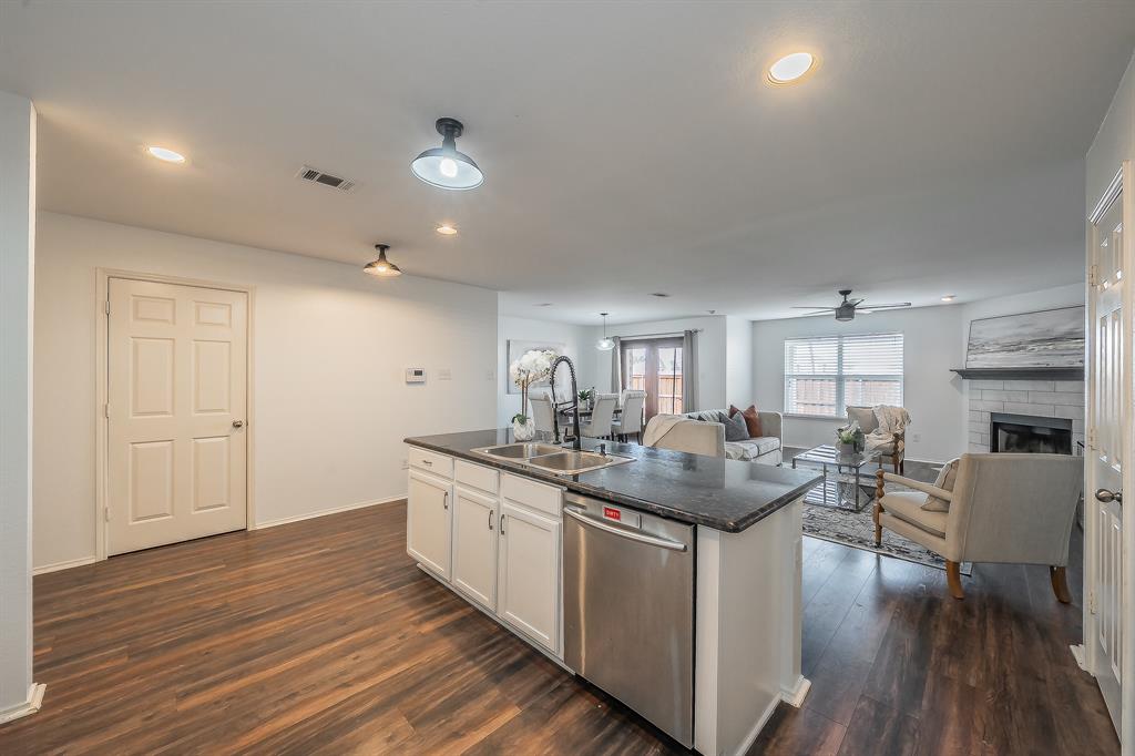 10541 Rising Knoll Lane Fort Worth, TX 76131 - Photo 27 of 27 a kitchen with center island cabinets and wooden floor