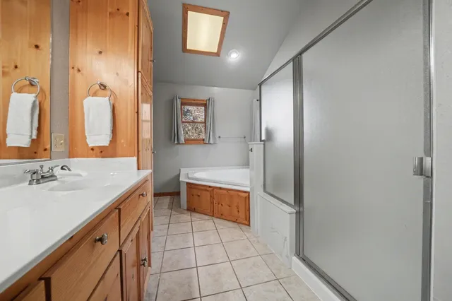 a view of a brick house with large windows and a roof