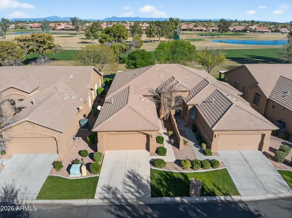an aerial view of a house with a garden and lake view