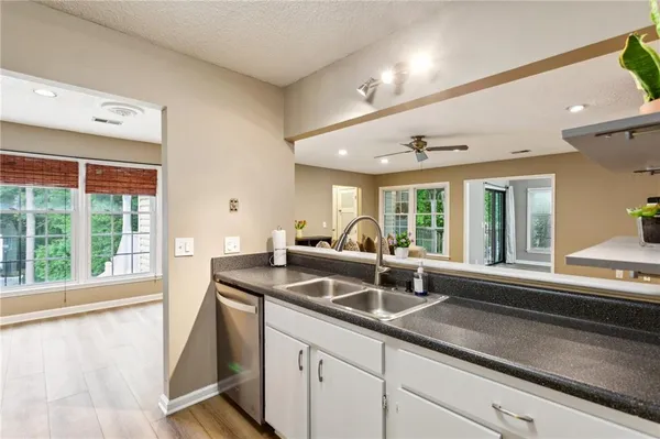a kitchen with granite countertop a sink and a window