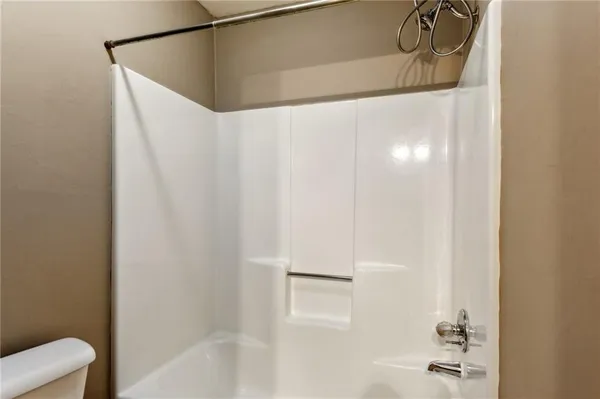 a bathroom with a shower and a sink