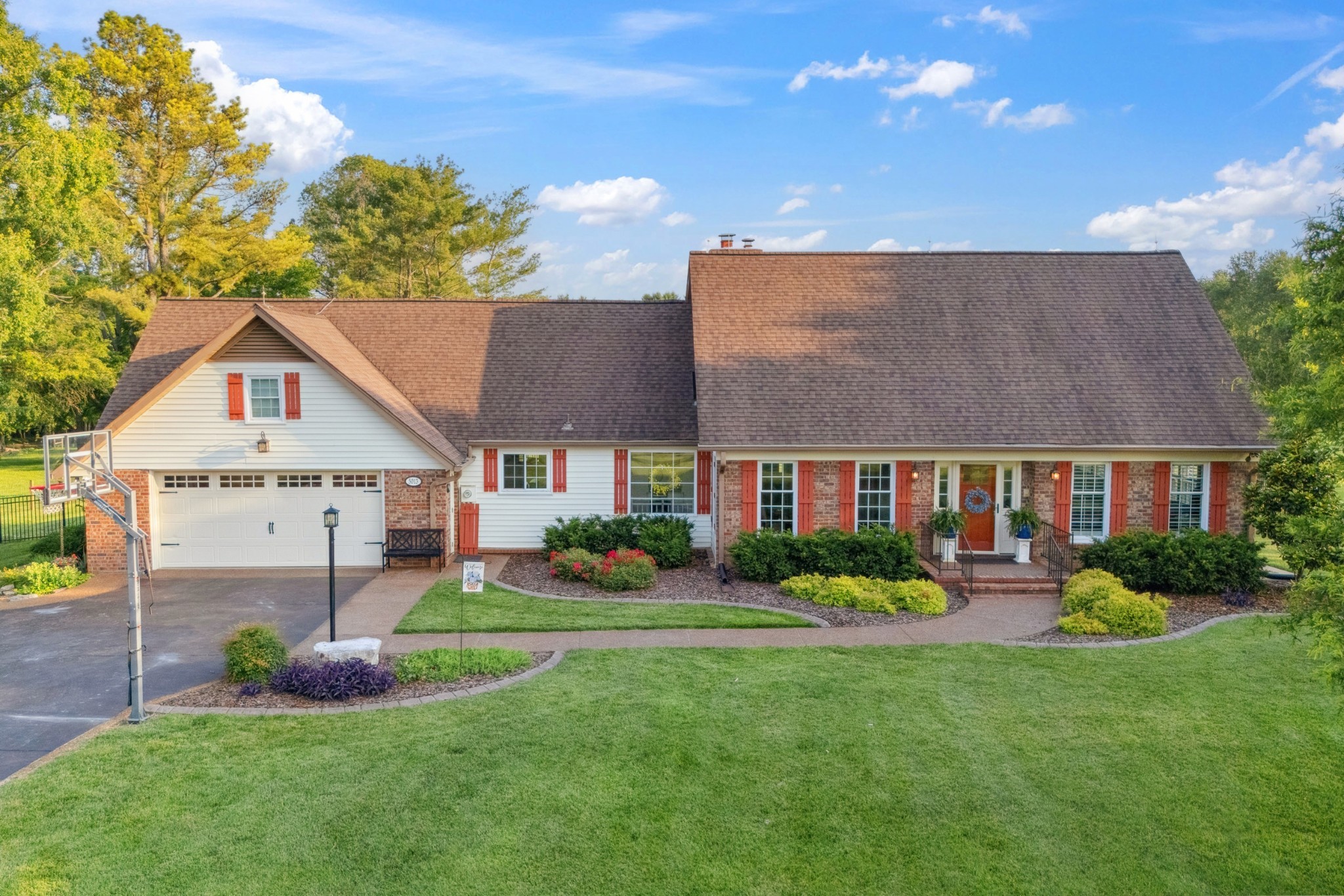 5013 Baker Road Murfreesboro, TN 37129 - Photo 1 of 55 a front view of a house with a garden and plants