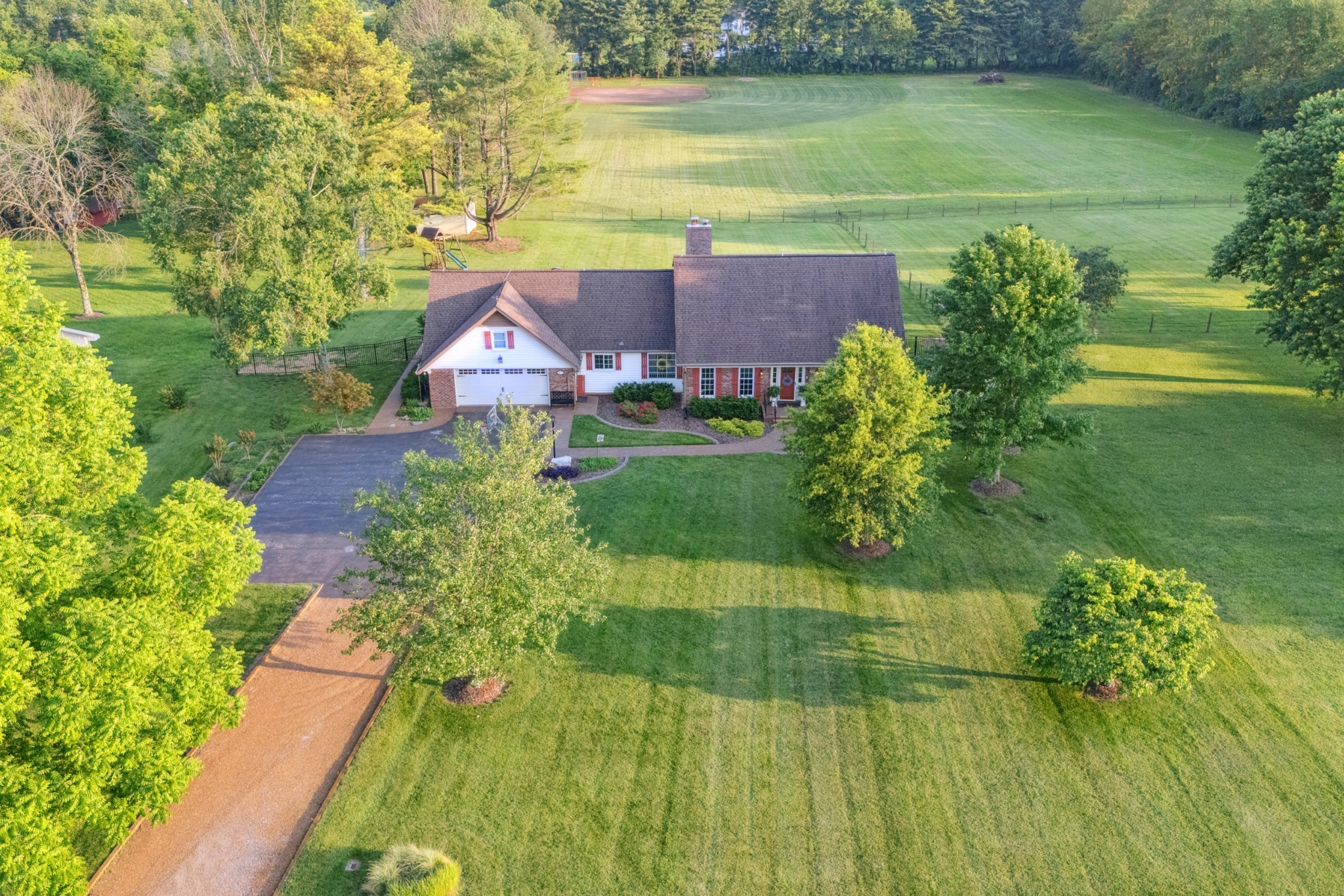5013 Baker Road Murfreesboro, TN 37129 - Photo 3 of 55 a view of a yard with plants and large trees