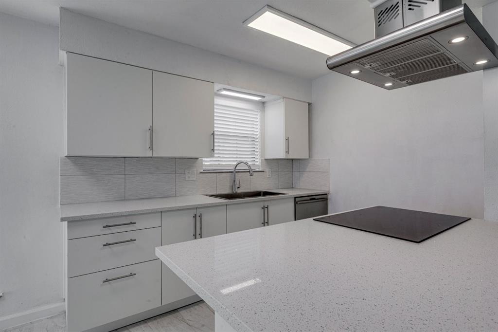 4606 Chaha Road, Unit 106 Garland, TX 75043 - Photo 13 of 22 Kitchen with island range hood, dishwasher, sink, white cabinets, and backsplash
