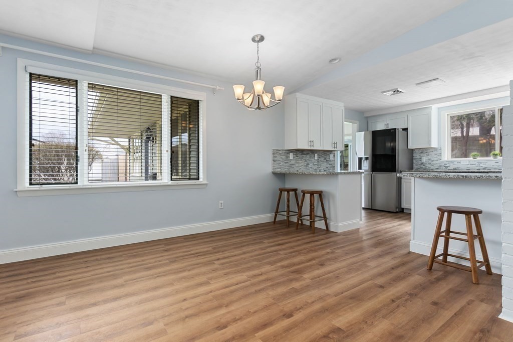 42 Amherst Road Beverly, MA 01915 - Photo 5 of 23 a living room with stainless steel appliances kitchen island granite countertop furniture and a wooden floor