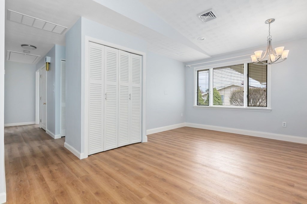 42 Amherst Road Beverly, MA 01915 - Photo 9 of 23 a view of an empty room with wooden floor and a window