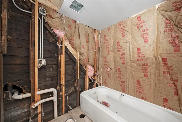 a bathroom with a bathtub and a shower
