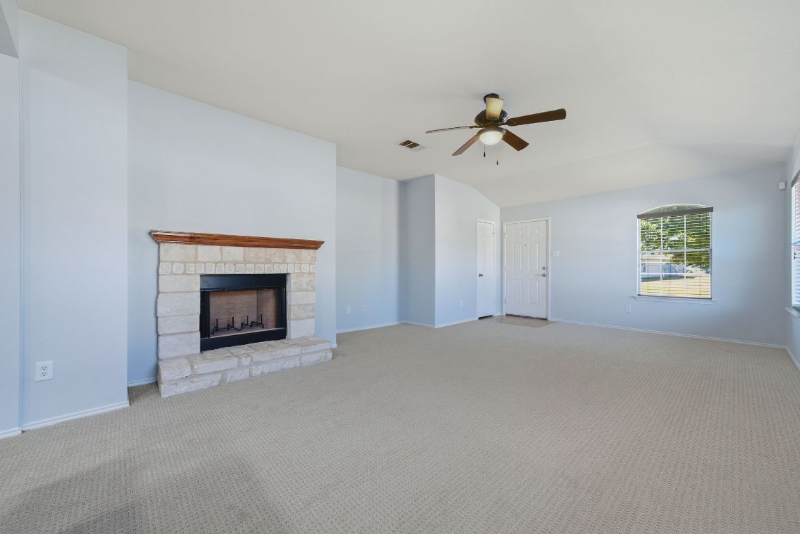 18153 Basket Flower Bend Elgin, TX 78621 - Photo 11 of 35 an empty room with windows and fireplace