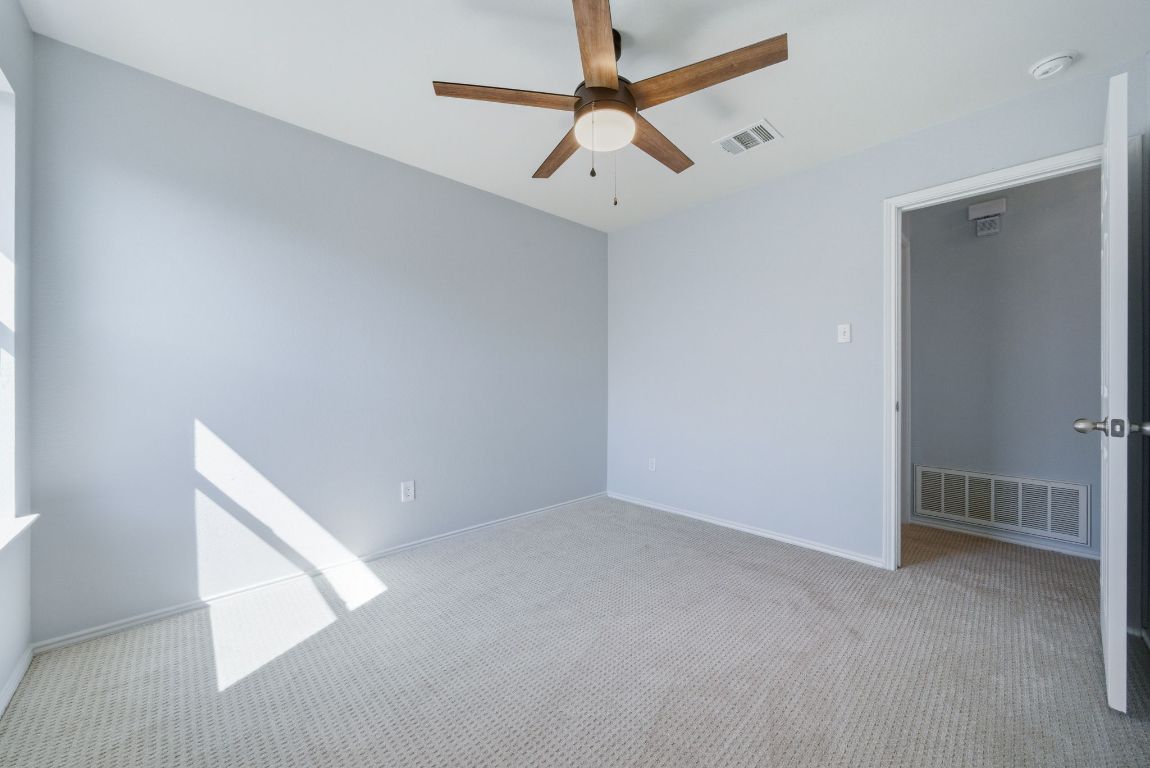 18153 Basket Flower Bend Elgin, TX 78621 - Photo 15 of 35 a view of an empty room with a ceiling fan