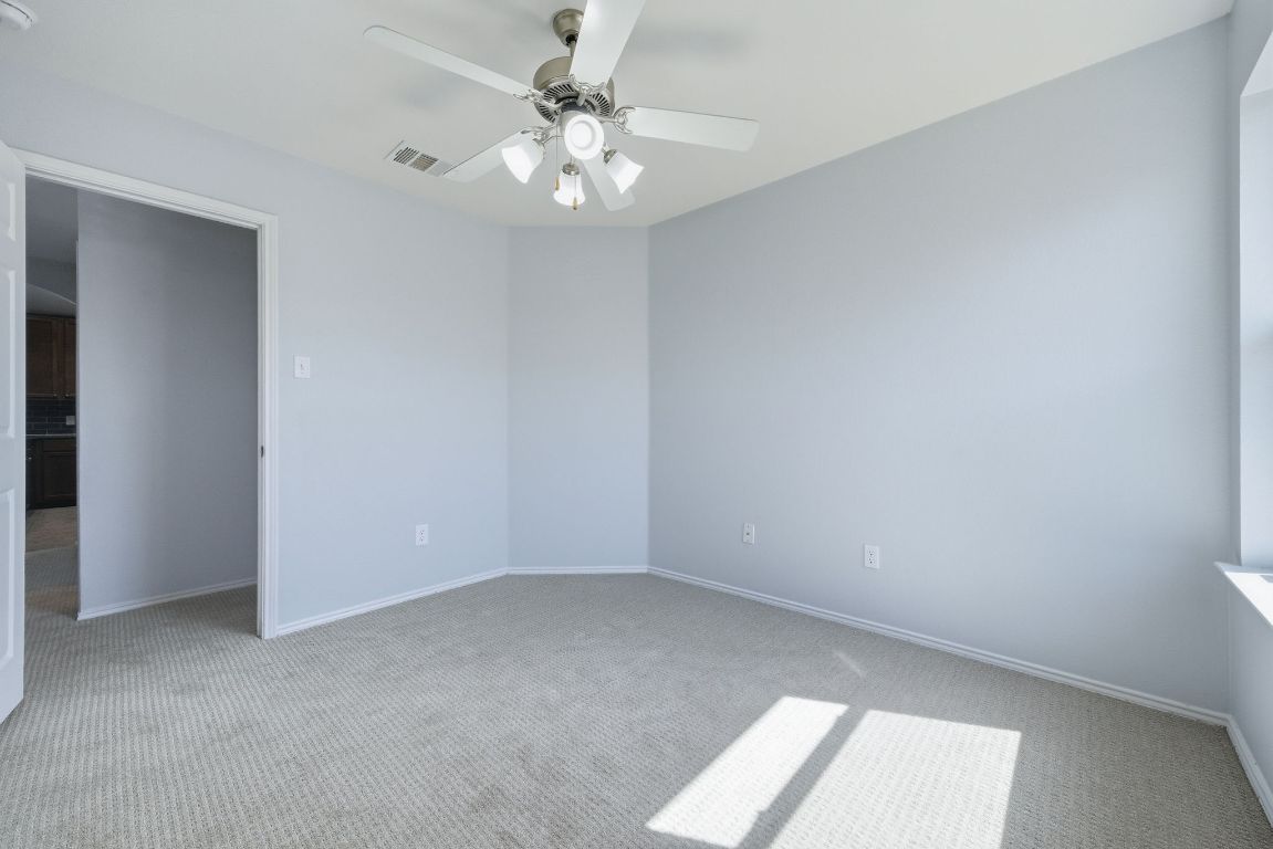 18153 Basket Flower Bend Elgin, TX 78621 - Photo 16 of 35 an empty room with a chandelier fan